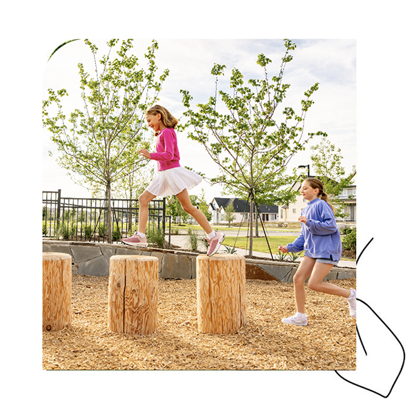 Two Kids Playing On Logs On Playground 