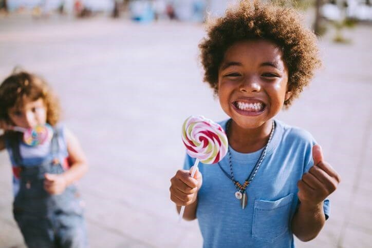 Excited boy with lollipop | The Grove Frisco in Texas