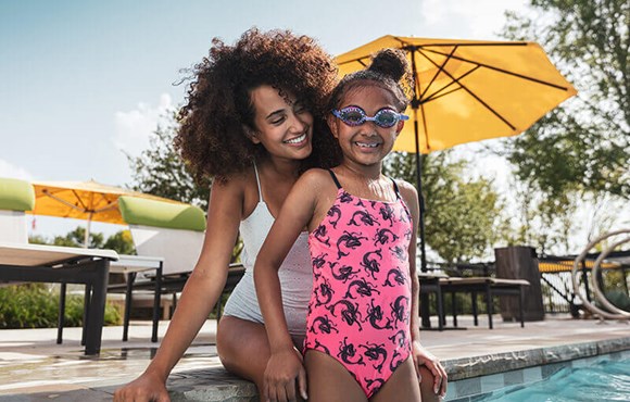 Mother and daughter at swimming pool in The Grove Frisco community