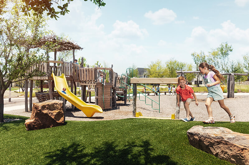 Kids playing on playground at park in The Grove Frisco community Frisco, TX