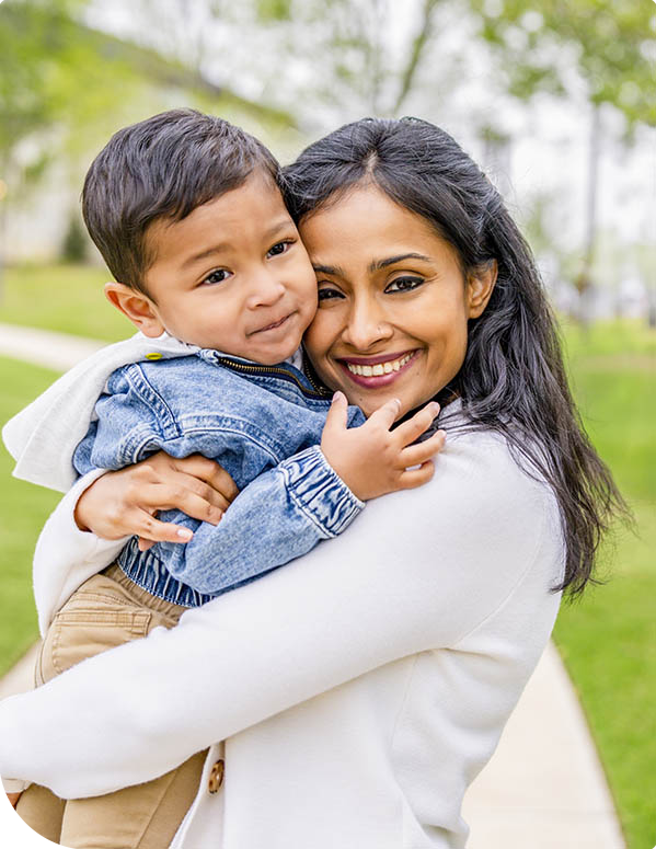 woman holding boy in park