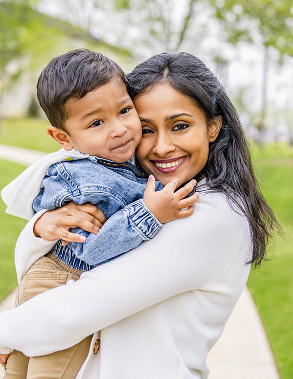 Woman Holding Boy In Park